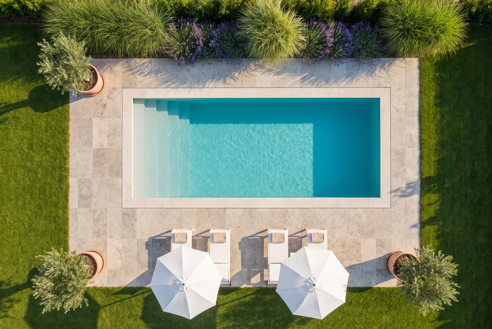The same backyard after: a pool with a stone terrace